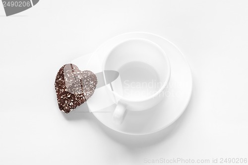 Image of cup and saucer and a chocolate coconut cookies