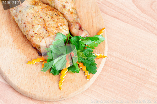 Image of Fried chicken legs with parsley on the board