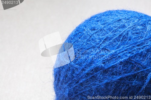 Image of blue wool yarn skein on cardboard background