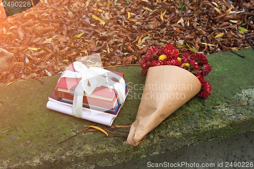 Image of bouquet of chrysanthemums and a stack of books