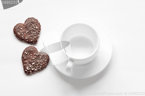 Image of cup and saucer and a chocolate coconut cookies