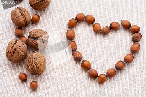 Image of walnuts, hazelnuts on a wooden background