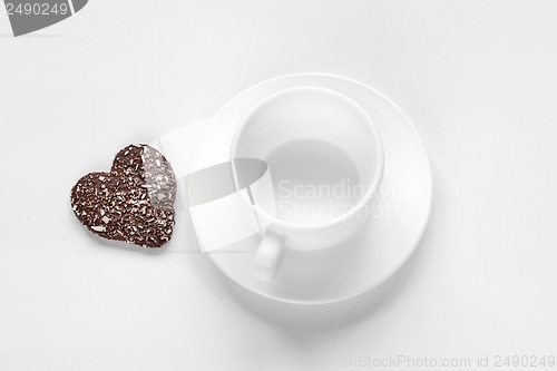 Image of cup and saucer and a chocolate coconut cookies
