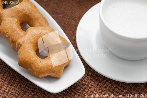 Image of honey cookies on a plate and a cup of milk