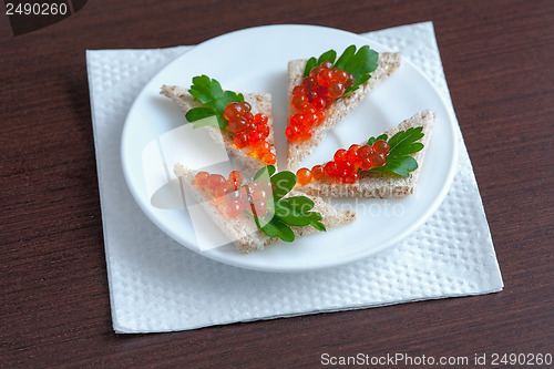 Image of Sandwiches with red caviar and parsley