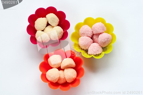 Image of sweet jelly candies in cup cake cases on white