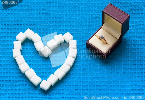 Image of engagement ring and sugar hearts