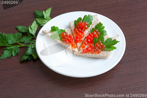 Image of Tartlets with caviar and parsley on a plate