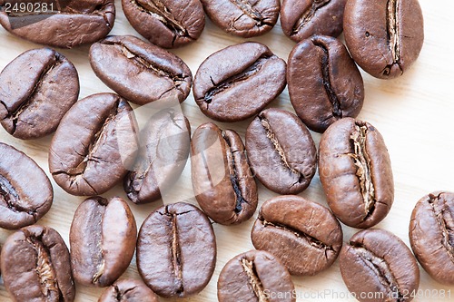 Image of coffee beans on white wooden background