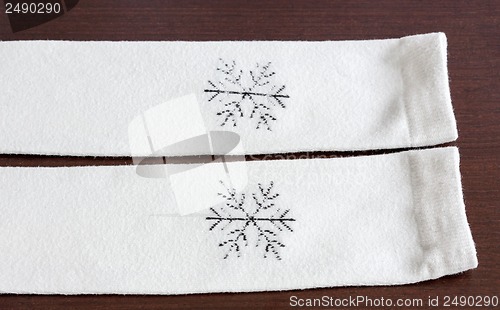 Image of Warm knitted socks on wooden table close-up