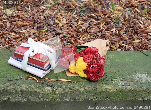 Image of bouquet of chrysanthemums and a stack of books