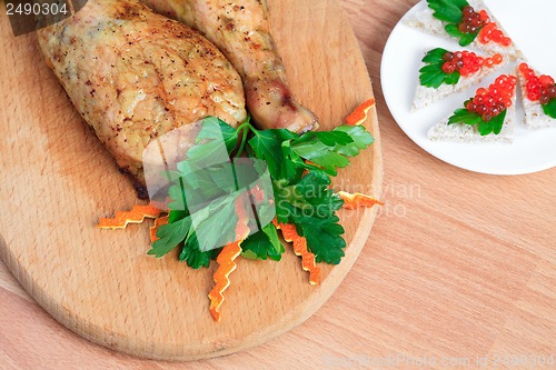 Image of Fried chicken legs with parsley and red caviar