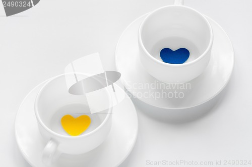 Image of empty cup and saucer with hearts