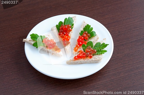 Image of Tartlets with caviar and parsley on a plate