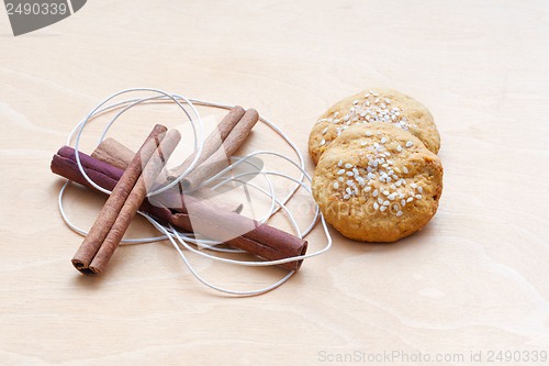 Image of biscuits, cinnamon sticks and a cord