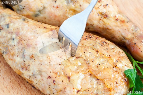 Image of Pierce the chicken with a fork on a cutting board