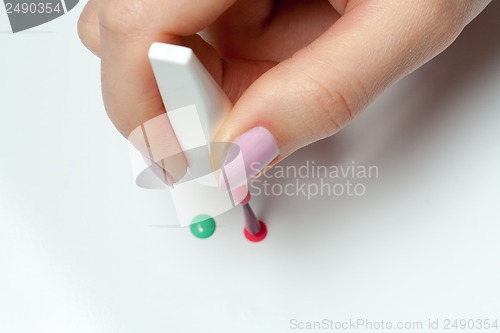 Image of woman's hand with a brush of nail polish