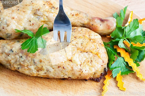 Image of Pierce the chicken with a fork on a cutting board