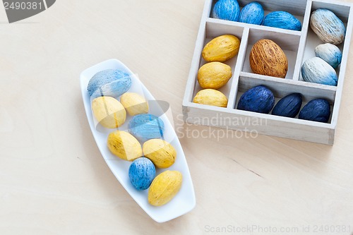 Image of dish with nuts next to the box full of nuts