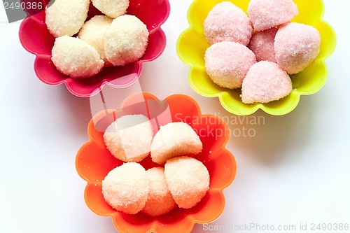 Image of sweet jelly candies in cup cake cases on white