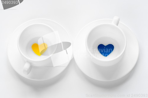 Image of empty cup and saucer with hearts