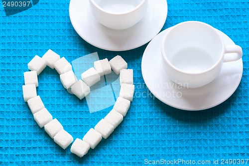 Image of White Sugar in heart shape on blue napkin