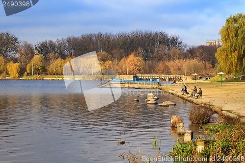 Image of Catching of fish fishermen on a lake in autumn