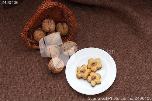 Image of wicker basket with nuts and pastry on a plate