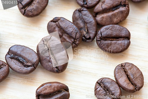 Image of coffee beans on white wooden background