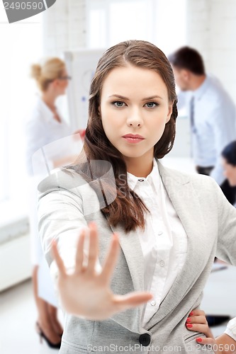 Image of angry businesswoman showing stop gesture
