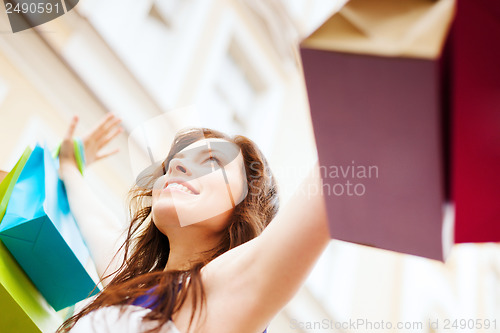 Image of woman with shopping bags in ctiy