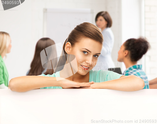 Image of smiling student girl with white blank board