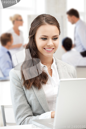 Image of businesswoman with laptop computer at work