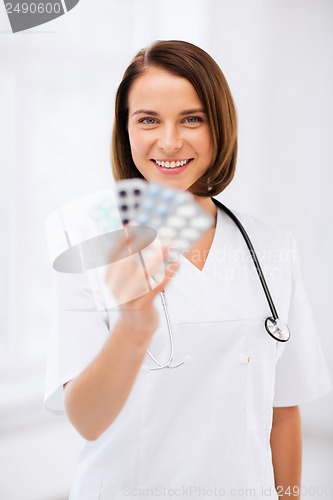 Image of doctor with blister packs of pills