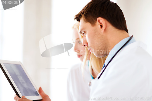 Image of two doctors looking at x-ray on tablet pc