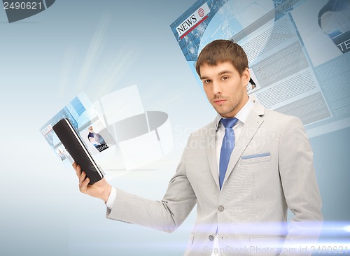 Image of businessman with tablet pc reading news
