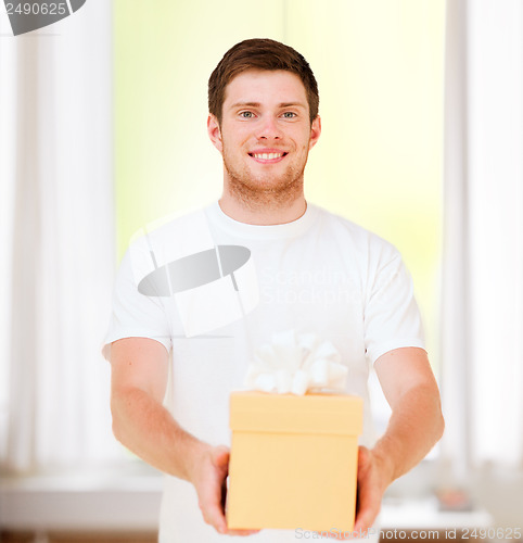 Image of man in white t-shirt with gift box