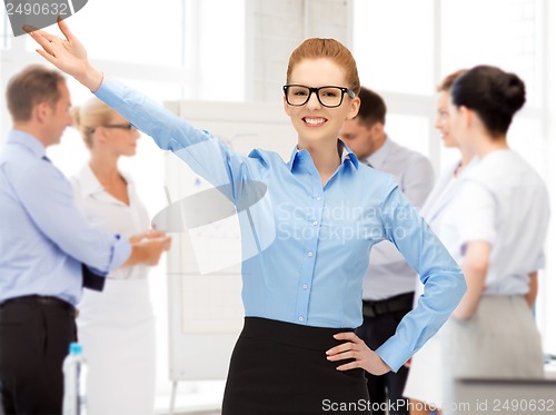 Image of attractive young businesswoman in office