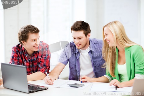 Image of students chatting in lecture at school