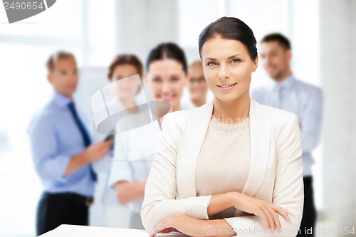 Image of attractive young businesswoman in office