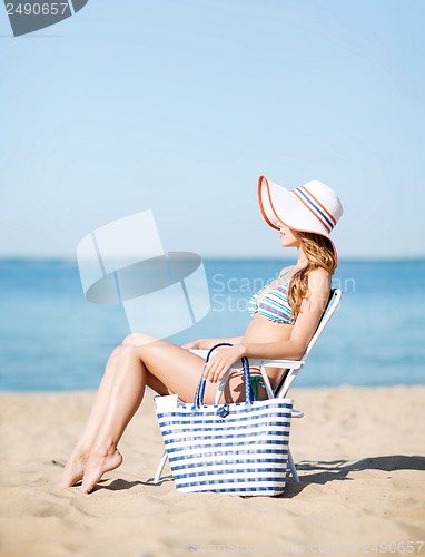 Image of girl sunbathing on the beach chair