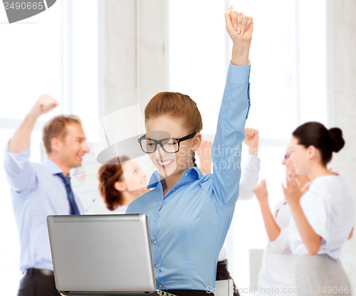 Image of businesswoman with computer in office