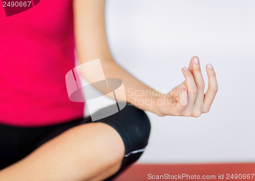 Image of girl sitting in lotus position and meditating