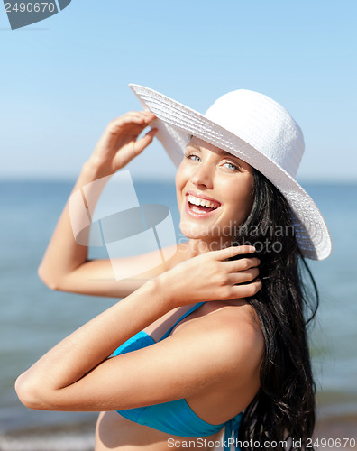 Image of girl in bikini standing on the beach