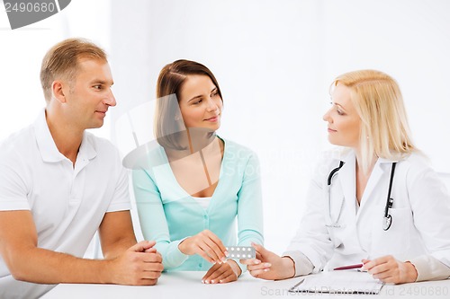 Image of doctor giving pills to patients