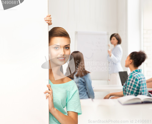 Image of smiling student girl with white blank board