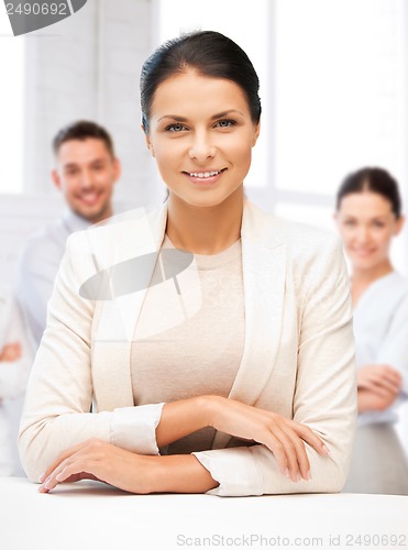 Image of attractive young businesswoman in office