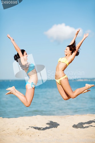 Image of girls jumping on the beach