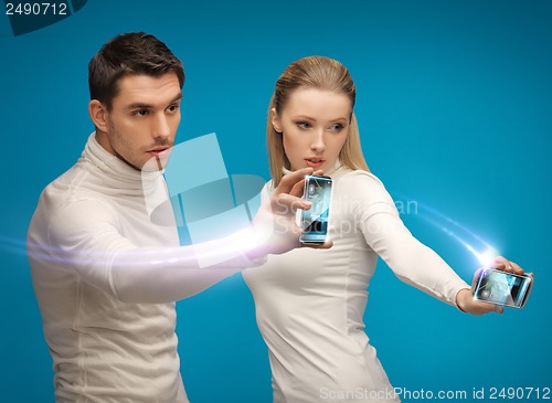 Image of futuristic man and woman working with gadgets