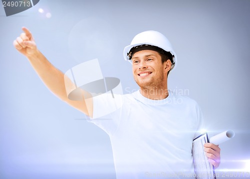 Image of male architect in helmet with blueprint